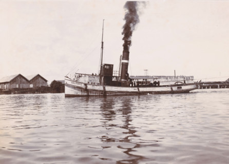 Tugboat 'Celebes', Ocean Harbor Belawan, photograph, The tugboat 'Celebes' with smoking chimney.