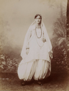 Portrait of a standing woman in front of a painted background, photograph, Portrait of a standing