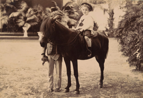 Portrait of an unknown child on a small horse with a servant, cabinet photograph, Illustration of a