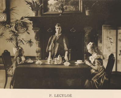 Woman stands behind a table where two children are drinking tea, Sentiment d'Art en Photographie,