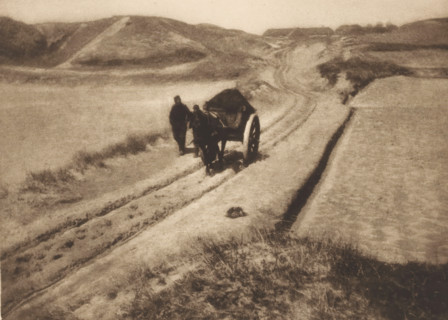 View of two unknown men with a cart on a path through the dunes, The road through the dunes, page,