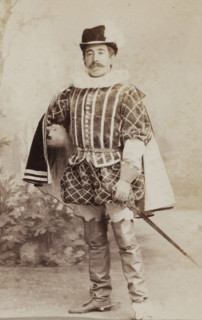 Portrait of a young man in costume with sword, identified as W. Birnie, album page, photograph,
