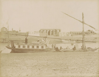 Sailboat (dahabie) on the Nile with the Great Colonnade in Luxor in the background, photograph,