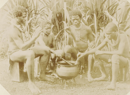 Four black men sitting around a cooking pot in South Africa, Kaffirs, photograph, Part of Album