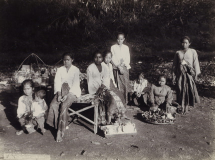 Women and children with goods displayed along the side of the road, Indies women and children with
