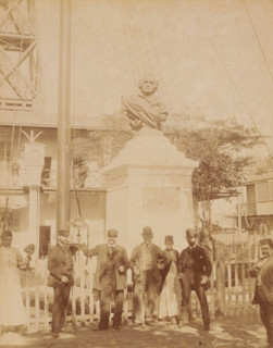 Six men and a woman standing in front of a monument, probably in Egypt, Agence du Terelain,