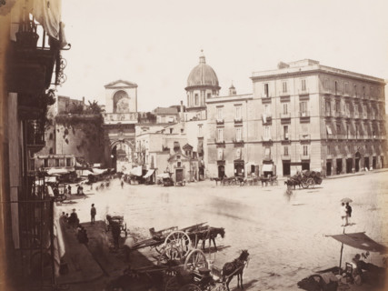 View of a square with the Porta Capuana and the dome of Santa Caterina a Formiello in Naples,