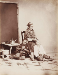 Naples, Scene in Naples with a woman removing fleas from the hair of two boys, photograph,