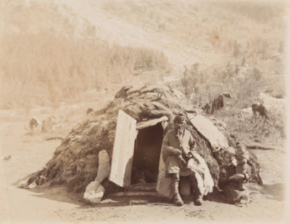 Family in front of their home (gamme) in Sápmi, Family in front of a round hut in Lapland (former