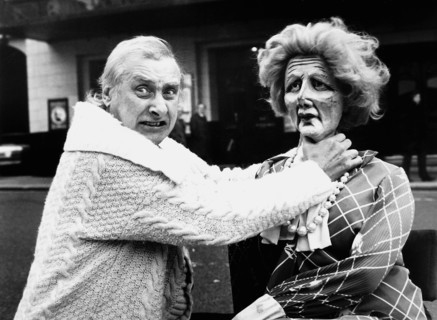 Spike Milligan strangling a doll of Margaret Thatcher with his hands
April 2002