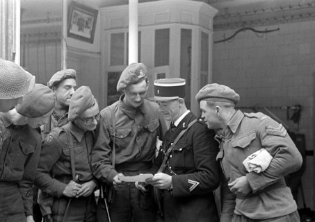 Soldats britanniques parlant avec un gendarme français, en juillet 1944