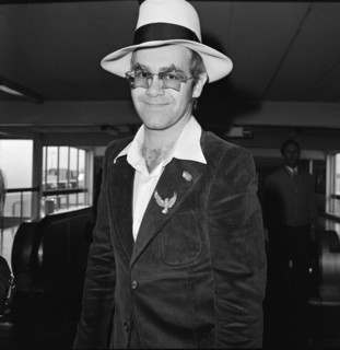 Elton John leaves Heathrow Airport. He is going to Los Angeles for the party of Elton John's