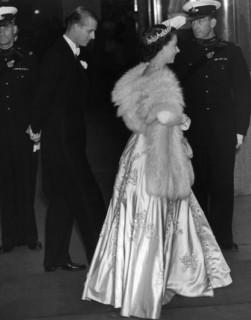 Princess Elizabeth wearing an elegant long dress and fur stoll attends an the premiere of the film