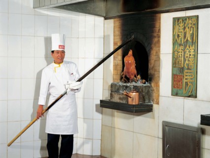 A cook makes Beijing roasted duck