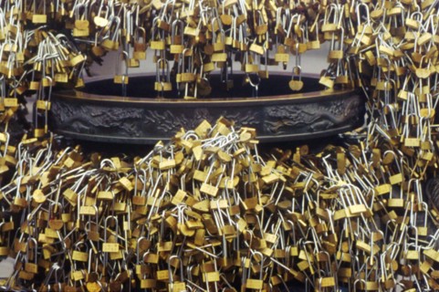 Innumerous locks adhered to a copper incense burner in Taishan mountain, China