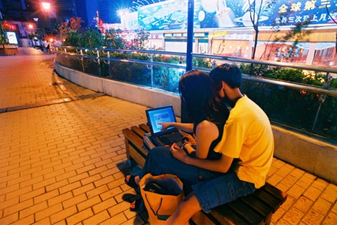 A couple sit on the street chair in Shanghai,China