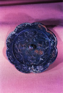 A bronze mirror with design of dragon, phoenix and sunflower dated from Tang Dynasty,China