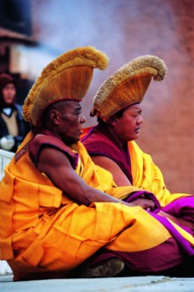 Two Lamas sit in the courtyard of Labrang Monasery,Xiahe,Gansu,China