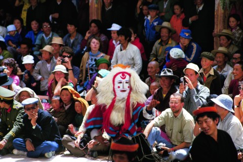 Visiters watch Tibetan Opera in Drepung Monastery, Tibet,China