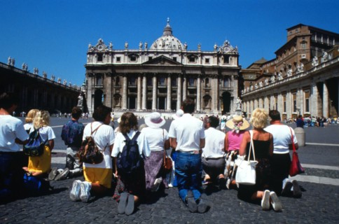 Pilgrims pray in front of St Peter`s, centre of the Roman Catholic church in Rome