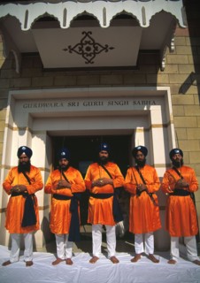 Five men who represent the Panj Piarey outside the gurdwara