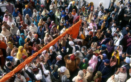Pulling a new cover on the flagpole at Baiskahi festival, Sikh New Year, India