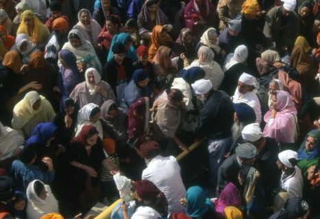 Washing the flag-pole with yoghurt, at the Baisakhi festival, India
