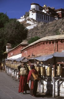 Pilgrims chanting mantras as they spin prayer wheels, Potala Palace, Lasha, Tibet