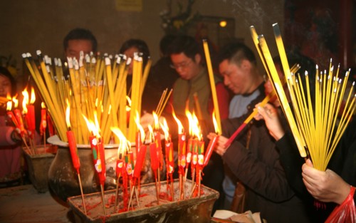 Chinese worship with burning joss sticks in a temple in Hong Kong