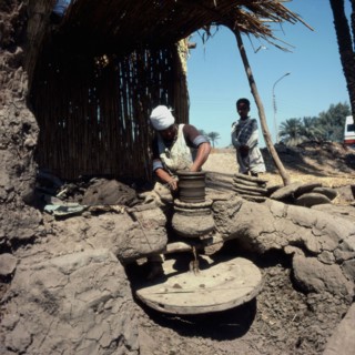 Potter making a vase on his wheel