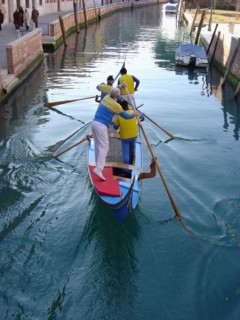 Yellow and blue gondola on Rio San Trovaso in Venice