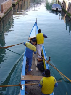 Yellow and blue gondola on Rio San Trovaso in Venice