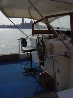 Helm of a boat with San Giorgio Maggiore behind
