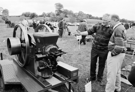Vintage engine on display at the Riverstown country fair, with men looking at it. County Sligo,