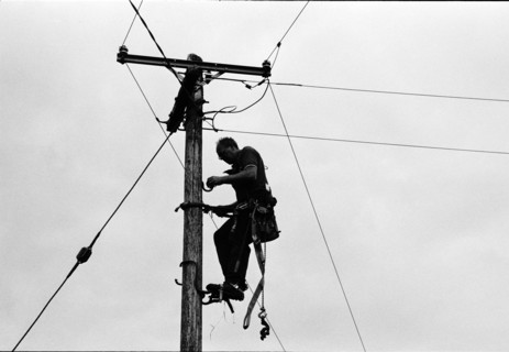 Worker climbing a pole for overhead line maintenance. County Mayo, Ireland.
2000