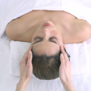 Woman receiving a head massage.
