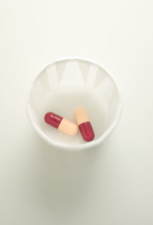 Medical capsules in a cup.