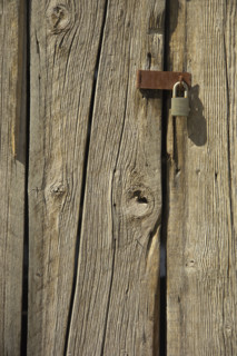 Padlock on a barn door.