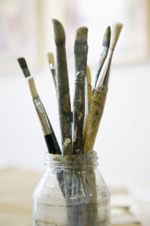 Paintbrushes in glass jar.
