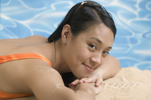 Woman reclining in swimsuit.