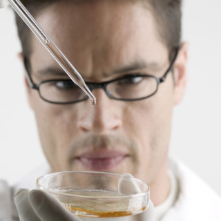 Lab technician with Petri dish.