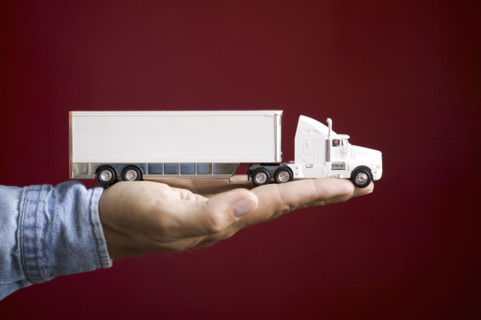 Close up of man's hand holding toy truck.