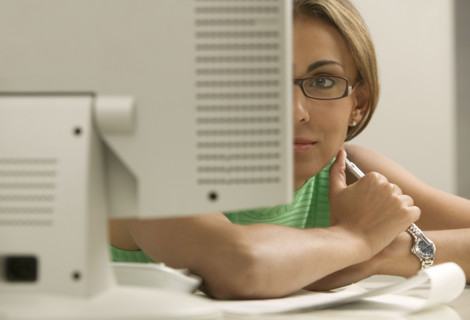 Woman looking at computer monitor.