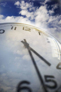 Close up of clock face and sky.