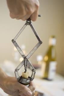 Opening a bottle of wine.