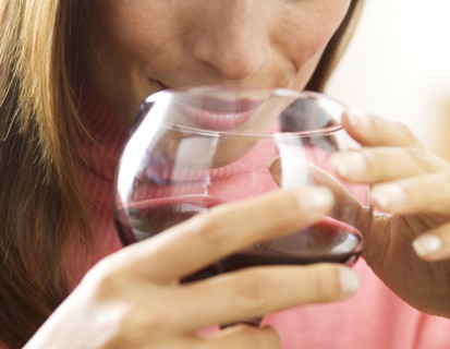 Woman holding a glass of wine.