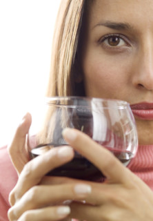 Woman holding a glass of red wine.