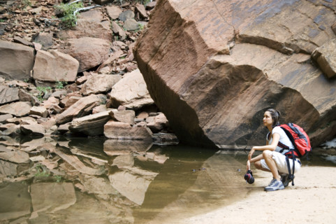 Female backpacker relaxing at a mountain lake.