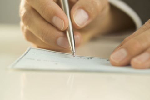 Man writing out a check.