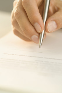 Man signing a document.